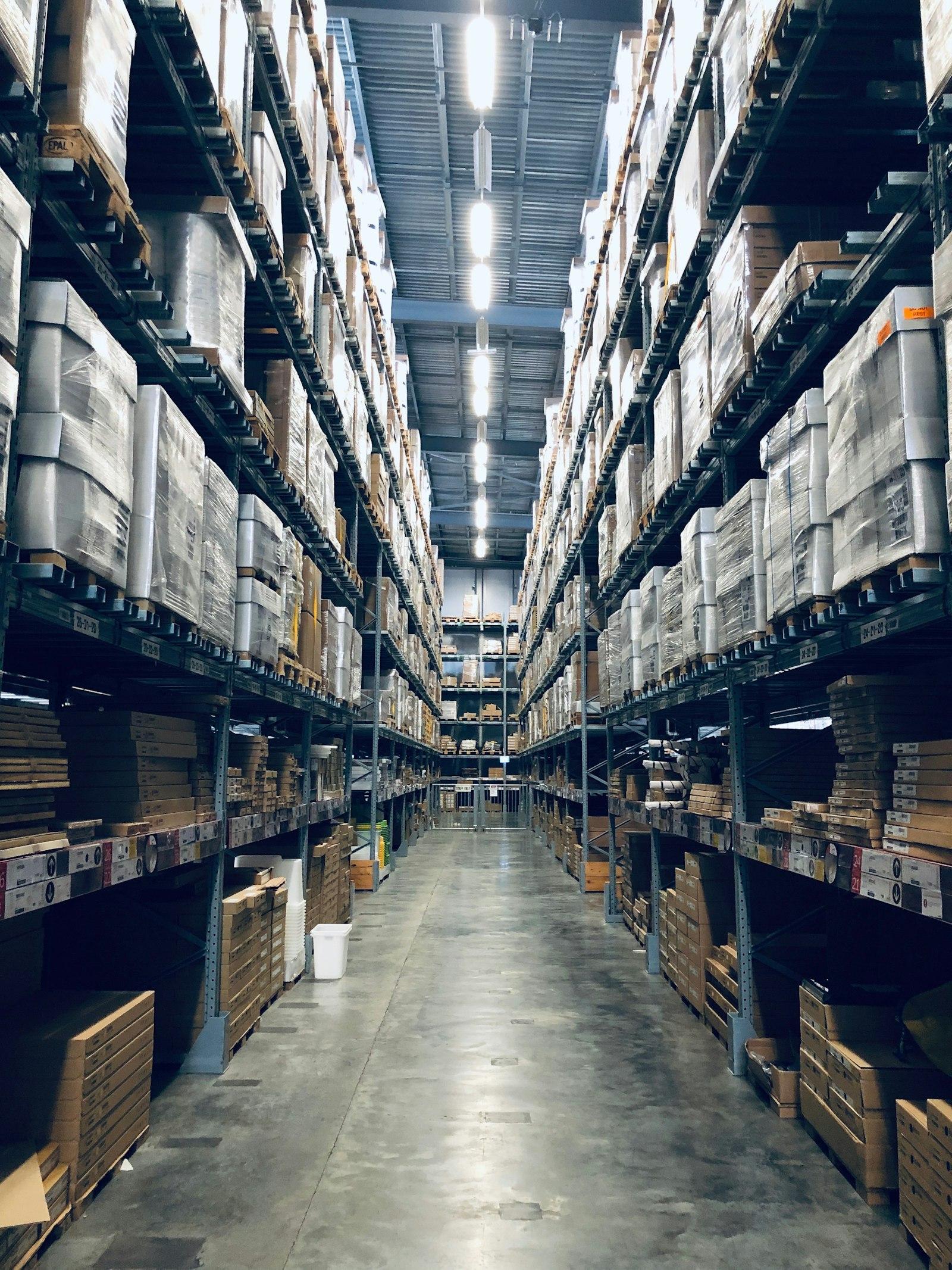 Tall warehouse racking aisle filled with palletised goods
